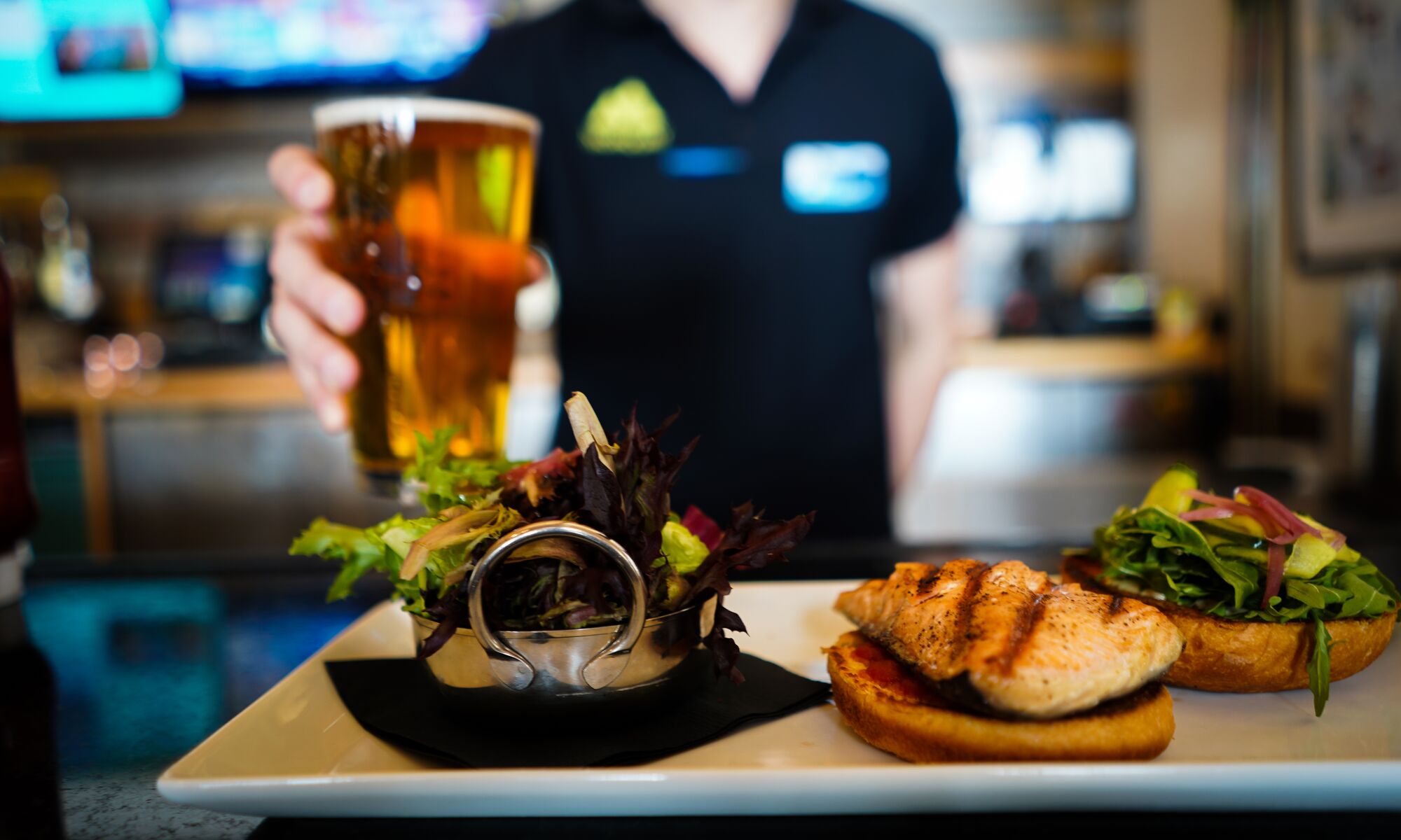 A burger and a drink being serverd at Lone Pine Lodge on Mt. Norquay in Banff National Park.